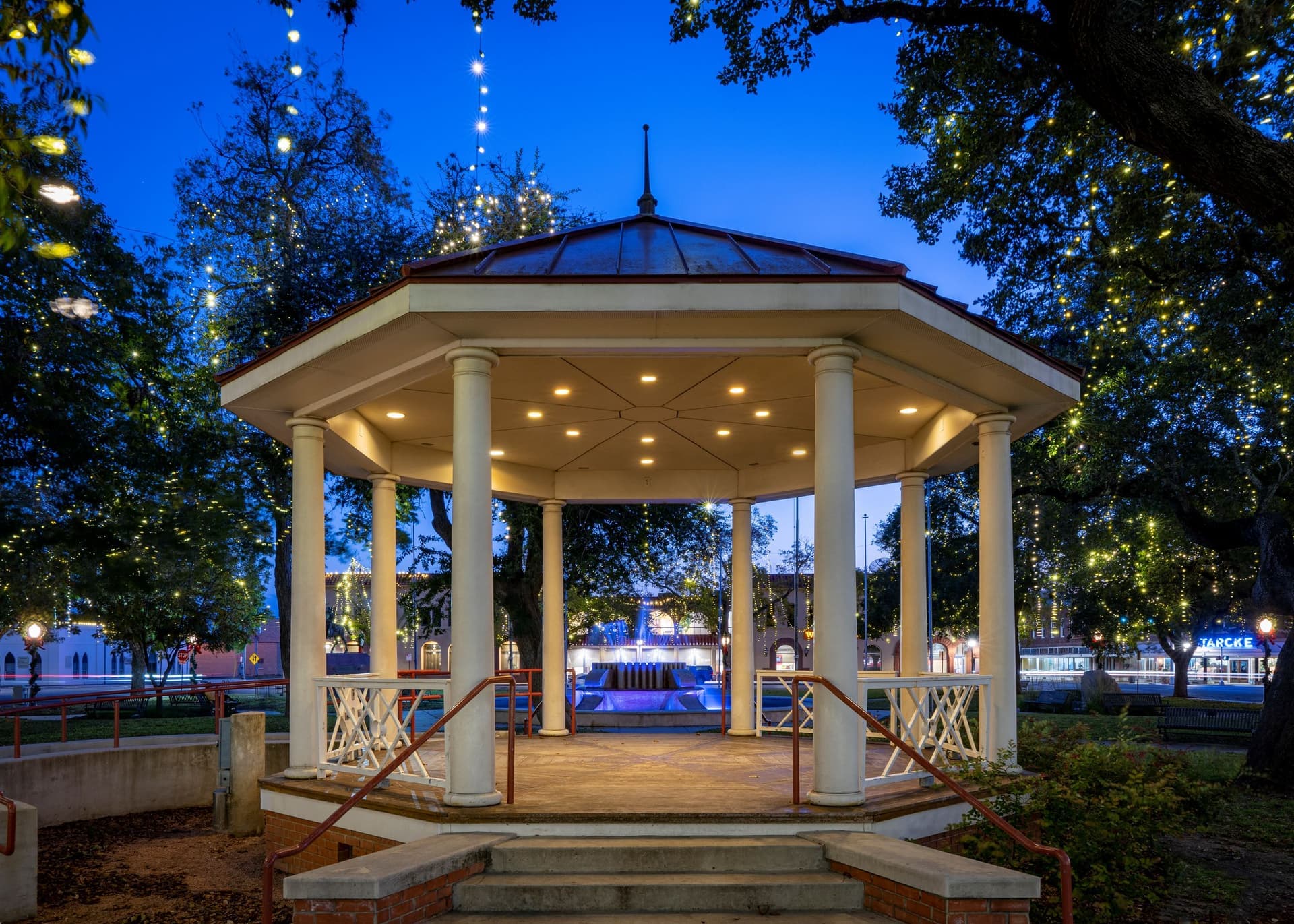 The gazebo in downtown Seguin glowing under string lights at night