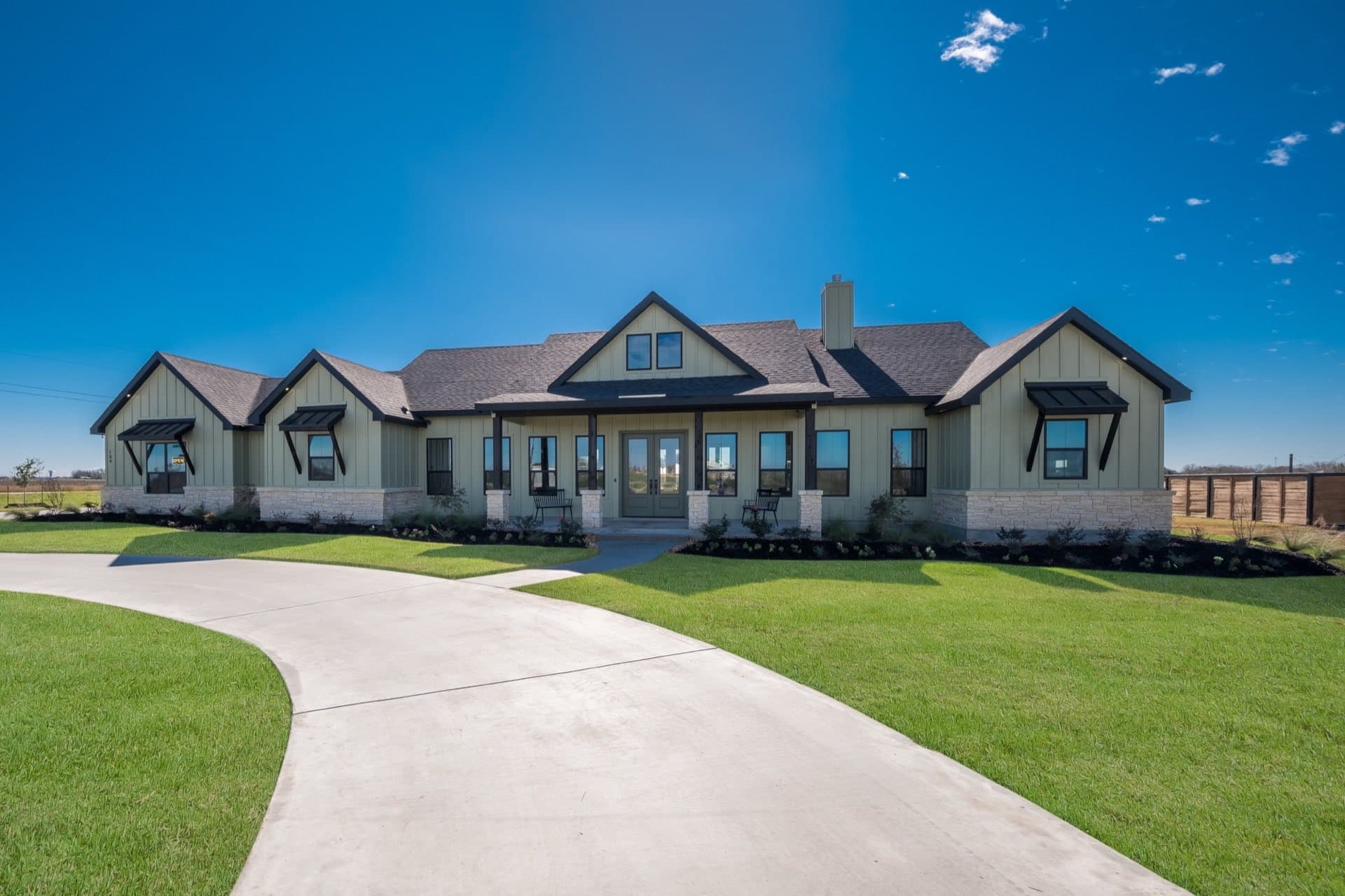 A finished TKG custom home under a clear blue Texas sky